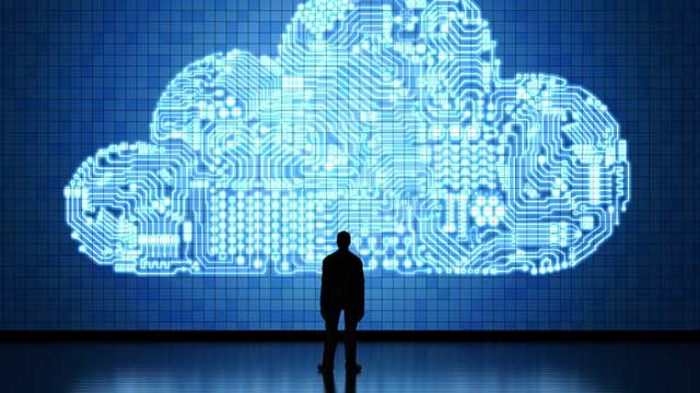 Silhouette of man in front of blue circuit board cloud
